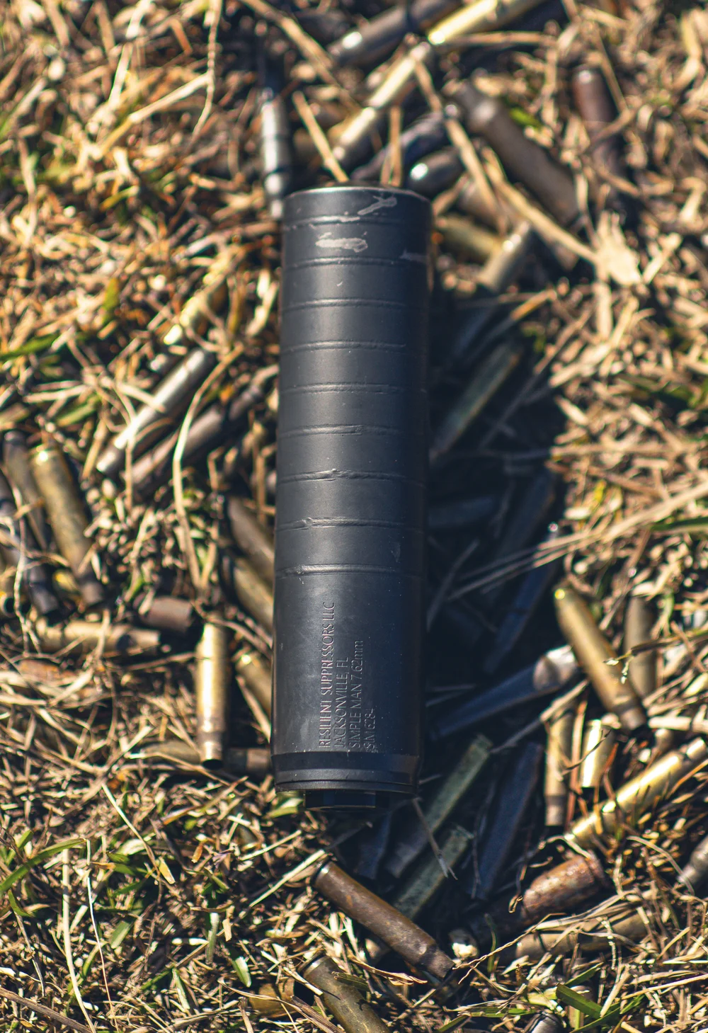 Suppressor standing in a bed of spent brass